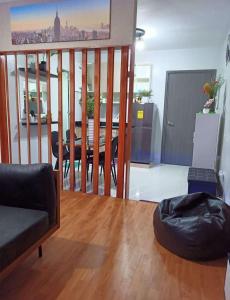 a living room with a table and a balcony at Rye Lees Place in Bacolod