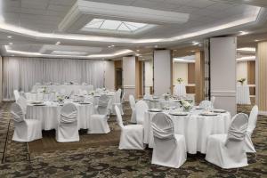 a room with white tables and white chairs and tablesearcher at Holiday Inn & Suites Oakville at Bronte by IHG in Oakville +94 photos
