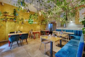 a restaurant with tables and chairs and plants at Salvator Boutique Hotel vegan-friendly in Prague