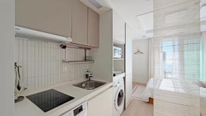 a kitchen with a sink and a washing machine at 윤슬 스테이-슬 in Sajin +16 photos