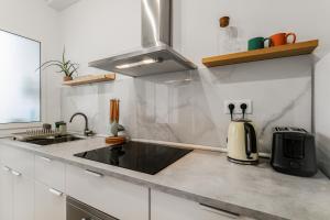 a kitchen with a sink and a coffee maker on the counter at VV Gara Galdar in Gáldar