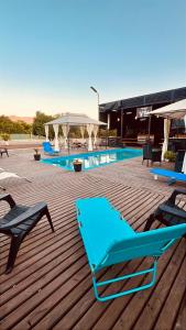 a blue lounge chair on a deck next to a swimming pool at El Rincon Secreto in Quillota