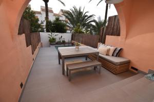 a small patio with a table and a bench at Barocco Villa private pool in Santa Pola