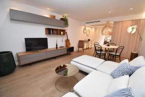 a living room with a white couch and a table at Barocco Villa private pool in Santa Pola
