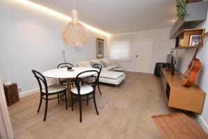 a living room with a table and chairs and a couch at Barocco Villa private pool in Santa Pola