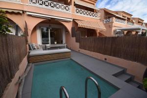 a swimming pool in front of a house at Barocco Villa private pool in Santa Pola
