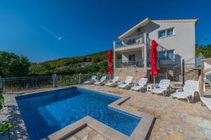 a villa with a swimming pool and a house at Holiday house Marijana in Zagvozd