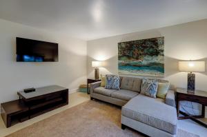a living room with a couch and a tv at Clipper Court 814 in Hilton Head Island