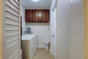 a small bathroom with a sink and wooden cabinets at Clipper Court 814 in Hilton Head Island +23 photos