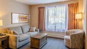 a living room with a couch and a chair at Cahilty #231 home in Sun Peaks