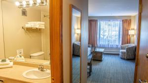 a hotel room with a bathroom with a sink and a mirror at Cahilty #231 home in Sun Peaks