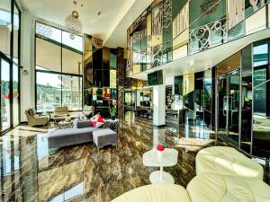 a living room filled with furniture and a lot of windows at Splendid Hotel @ Khaoyai in Mu Si