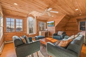 a living room with couches and a ceiling fan at Town & Tide Home for 8 in Kennebunkport
