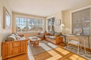 a living room with a couch and a table at Town & Tide Home for 8 in Kennebunkport +44 photos