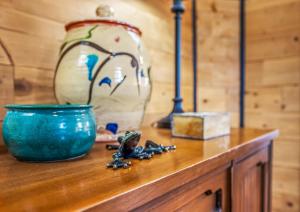 a wooden table with a blue bowl and a vase at Broadway Cottage - Town, Hot Tub, Fire Pit, Grill, Wifi, Family Friendly, Pet Friendly in Berkeley Springs