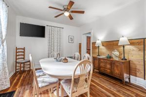 a dining room with a white table and chairs at Broadway Cottage - Town, Hot Tub, Fire Pit, Grill, Wifi, Family Friendly, Pet Friendly in Berkeley Springs