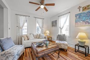 a living room with a couch and a table at Broadway Cottage - Town, Hot Tub, Fire Pit, Grill, Wifi, Family Friendly, Pet Friendly in Berkeley Springs