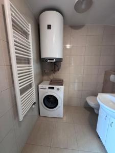a bathroom with a washing machine and a sink at Apartment Krajinka in Cheb