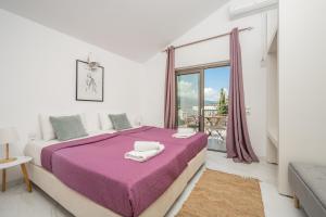 a white bedroom with a large bed and a window at Astarte Villas - Casa De Sun Private Villa with Pool in Zakynthos