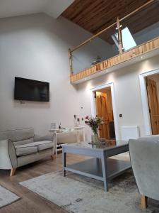 a living room with a couch and a table at Sessaigh lake studio in Dunfanaghy