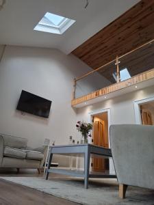 a living room with a couch and a table at Sessaigh lake studio in Dunfanaghy