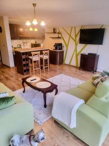 a living room with two couches and a table at Apartament Kleopatra in Limanowa