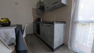a small kitchen with a sink and a stove at La Mola B&B in Vignanello