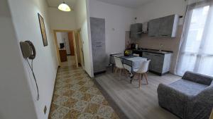 a kitchen and living room with a table and a couch at La Mola B&B in Vignanello