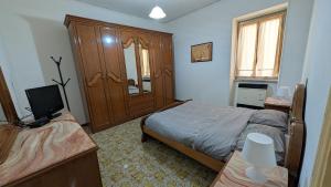 a bedroom with a bed and a television in it at La Mola B&B in Vignanello