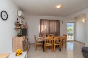 a kitchen and dining room with a table and chairs at Holiday house Marijana in Zagvozd