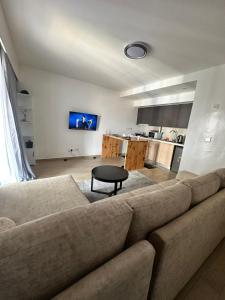 a living room with a couch and a table at BlaQ Homes in Kanga