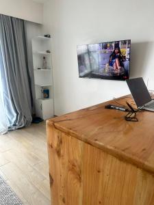 a room with a wooden table with a laptop on it at BlaQ Homes in Kanga +4 photos