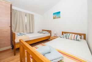 a bedroom with two beds and a window at Holiday house Marijana in Zagvozd +53 photos