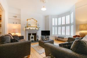 a living room with two couches and a fireplace at 3 Bed in Mumbles oc-hh1223 in The Mumbles