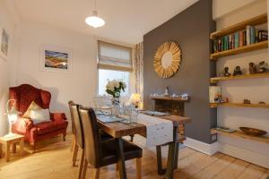 a dining room with a table and a chair at 3 Bed in Mumbles oc-hh1223 in The Mumbles