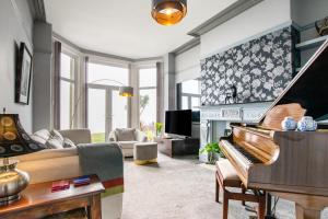 a living room with a piano and a couch at 2 Bed in Langland oc-hh142 in Newton