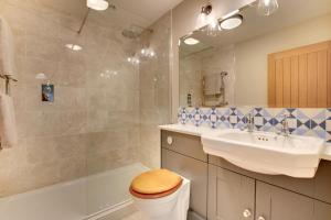 a bathroom with a toilet and a sink and a tub at 2 Bed in Builth Wells oc-bow198 in Builth Wells