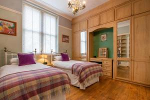 a bedroom with two beds and a chandelier at 2 Bed in Langland oc-hh142 in Newton