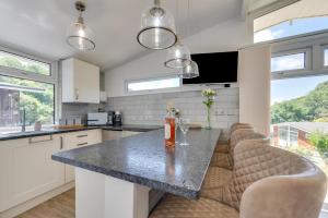 a kitchen with a large island with bar chairs at 2 Bed in Caswell Bay oc-hh379 in Newton