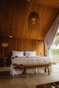 a bedroom with a large bed with a wooden ceiling at Pedras Do Patacho Hotel Boutique Experience in Pôrto de Pedras +146 photos