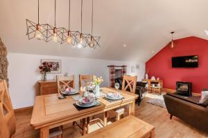 a living room with a wooden table and a couch at 2 Bed in Lixwm oc-bow179 in Halkyn