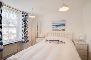a bedroom with a white bed and a window at 3 Bed in Beer oc-jbvalh in Beer