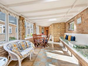a living room with a couch and a table at 4 Bed in Peterborough oc-93450 in Yaxley