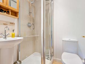 a bathroom with a shower and a toilet and a sink at 4 Bed in Peterborough oc-93450 in Yaxley +29 photos