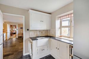 a kitchen with white cabinets and a sink at 4 Bed in Builth Wells oc-bow197 in Builth Wells +43 photos