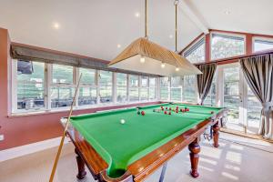 a pool table in a room with windows at 4 Bed in Builth Wells oc-bow197 in Builth Wells