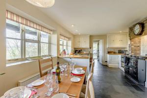 a kitchen with a table with wine glasses on it at 4 Bed in Builth Wells oc-bow197 in Builth Wells