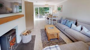 a living room with a couch and a table at 3 Bed in Llanbedrog oc-llynor in Llanbedrog