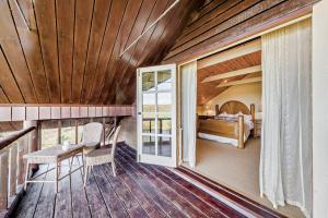 a room with a balcony with a bed and a table at 4 Bed in Builth Wells oc-bow197 in Builth Wells