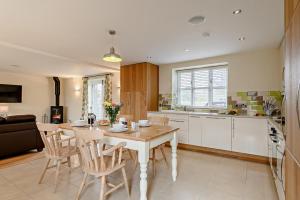a kitchen with a table and chairs in a room at 2 Bed in Gilwern oc-o27004 in Gilwern +13 photos